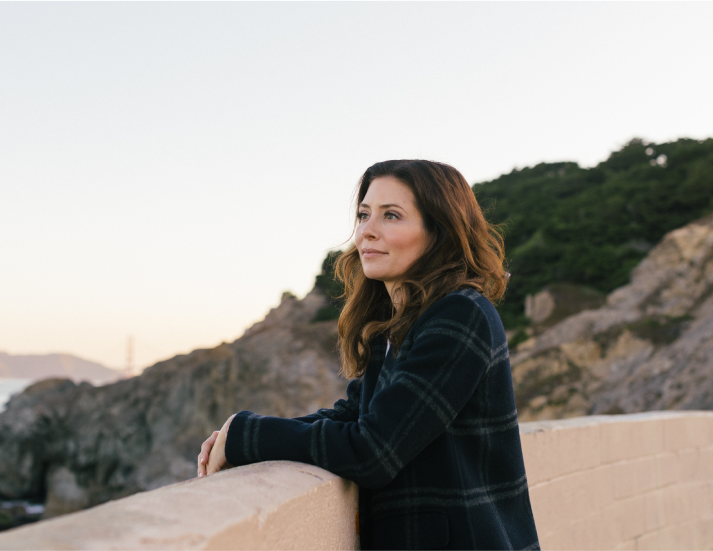 Dr. Campbell looking away while enjoying a mountain landscape in San Francisco, dressed in casual attire. A moment of relaxation outside the medical environment.