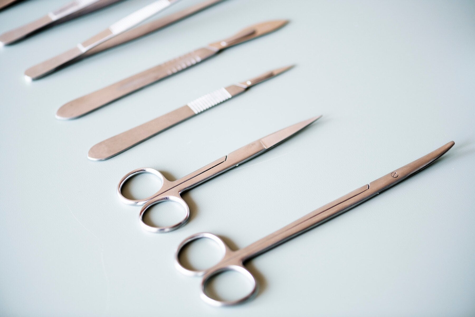 A set of sterilized surgical instruments neatly arranged, highlighting the importance of hygiene and infection control in medical and dermatological procedures.